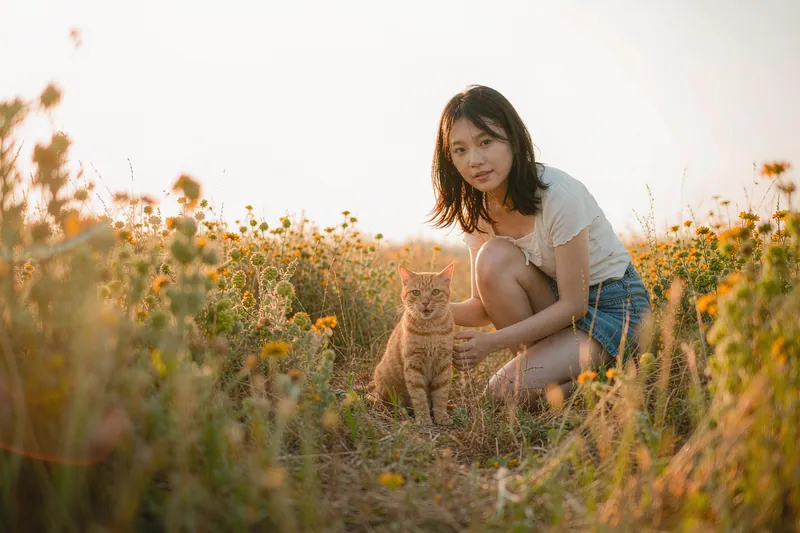 Golden Hour style — AI-generated sample of a woman with her ginger cat
